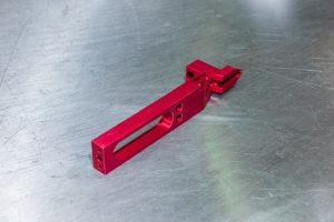 custom-concepts-kickout-arm-3 Red machined kick-out arm for a label printing machine
