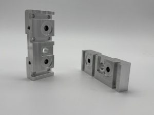 Machined rocker jogger blocks for a printing machine