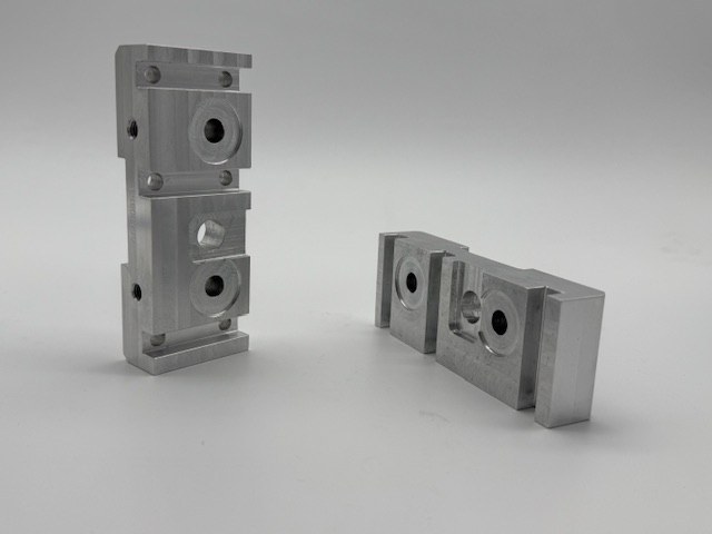 Machined rocker jogger blocks for a printing machine