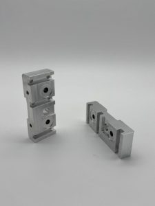 Machined rocker jogger blocks for a printing machine