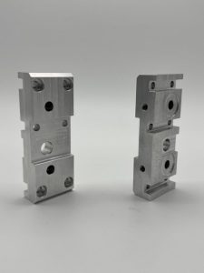 Machined rocker jogger blocks for a printing machine