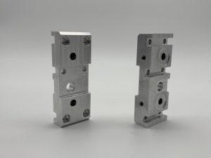 Machined rocker jogger blocks for a printing machine